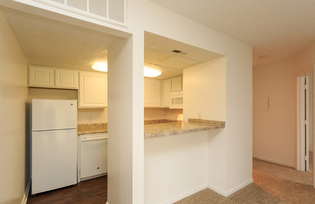 a view of a kitchen with a counter top and a refrigerator