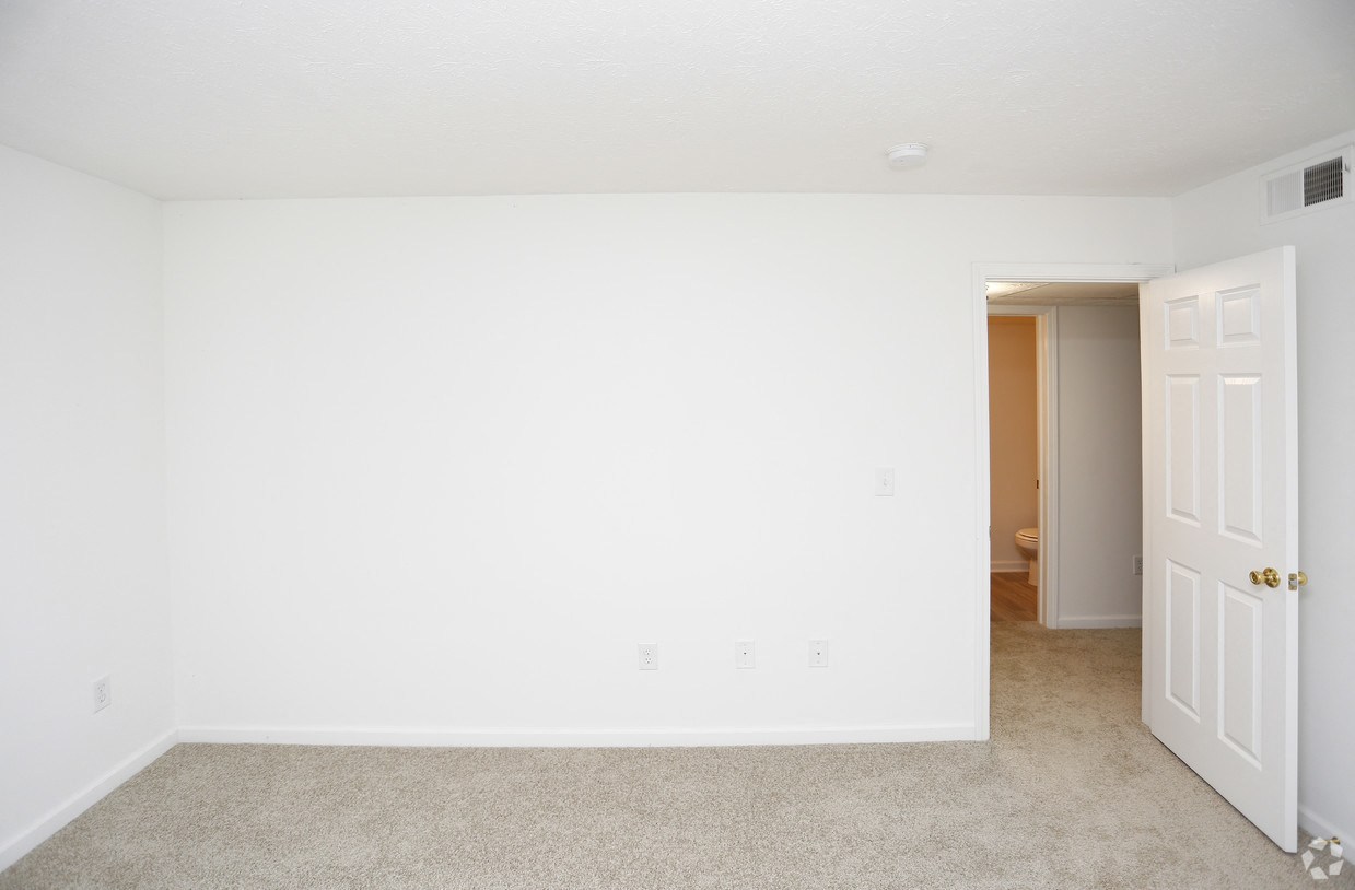 an empty room with a white wall and a white door