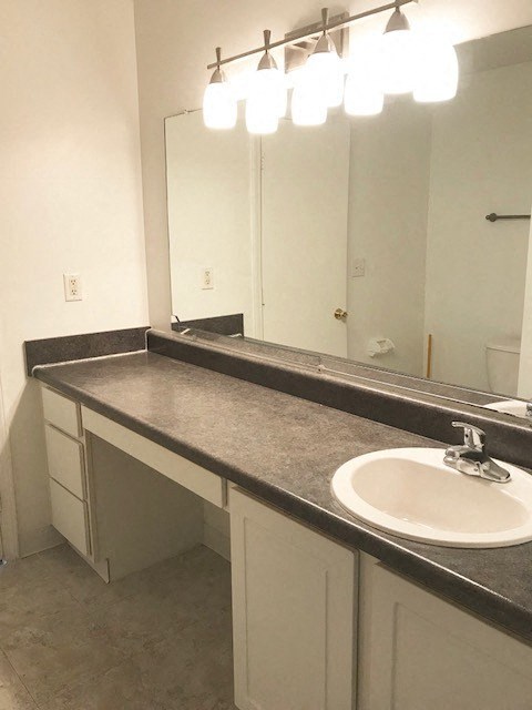 an empty bathroom with a sink and a mirror