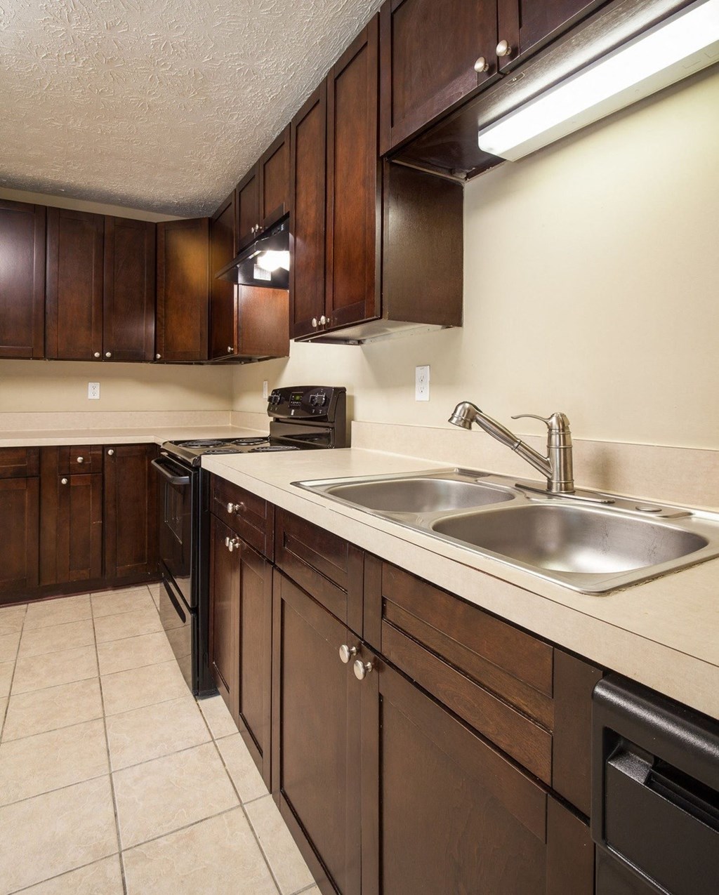 a kitchen with a sink and wooden cabinets
