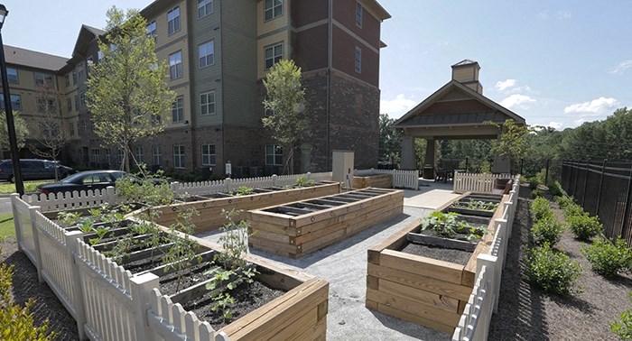 decatur affordable family apartment a community garden with a fence and a building