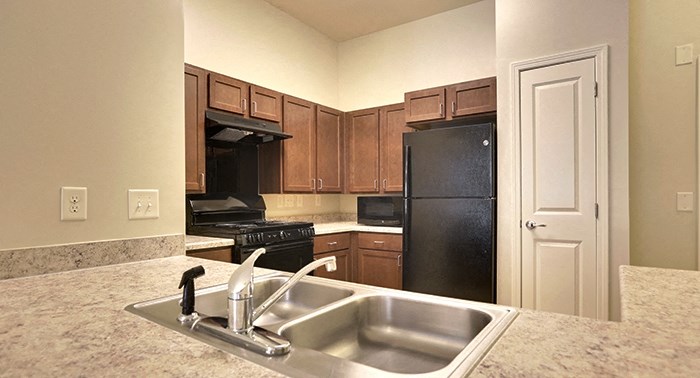decatur affordable family apartment a kitchen with a sink and a black refrigerator