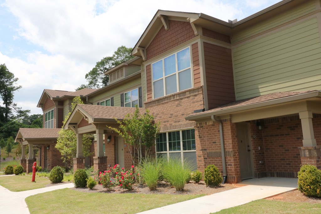 decatur affordable family apartment  a brick house with a sidewalk in front of it