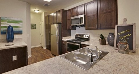 a kitchen with stainless steel appliances and granite counter tops