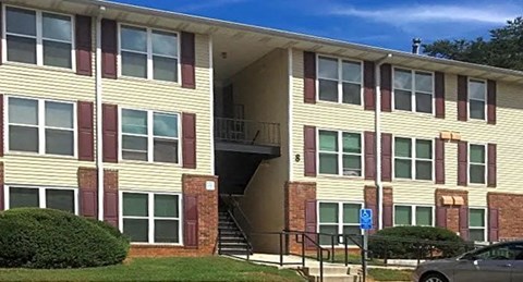 an apartment building with a car parked in front of it