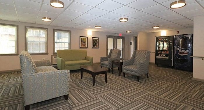 a room with chairs and a table in a lobby