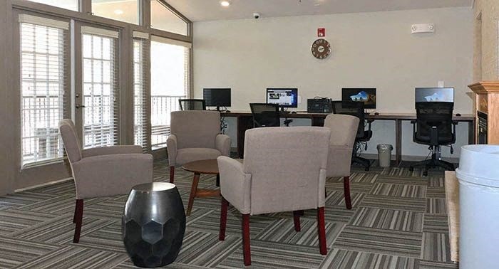 a conference room with chairs and computers in it