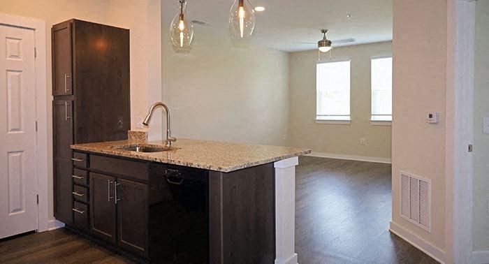 an empty kitchen with a sink and a counter top