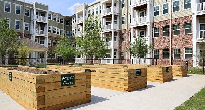 a wooden retaining wall in front of an apartment building
