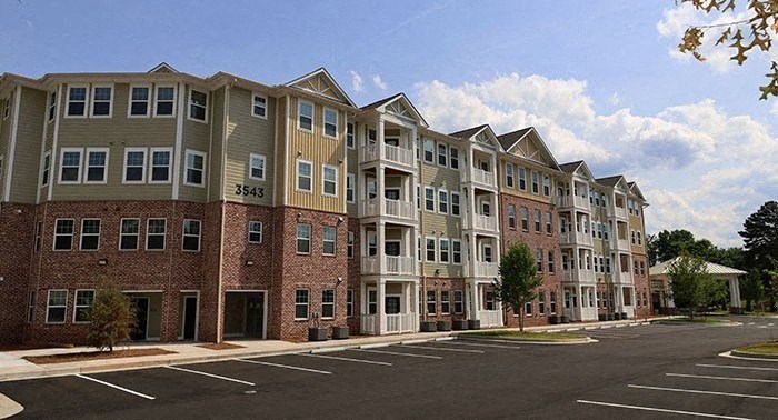 a row of apartment buildings on the corner of a street