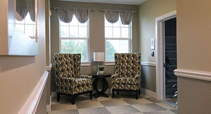a living room with two chairs and a table