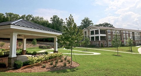 a large yard with a pavilion and some houses