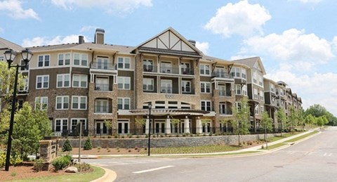 an image of an apartment building on the corner of a street