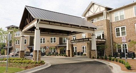 a building with an awning and a driveway in front of it