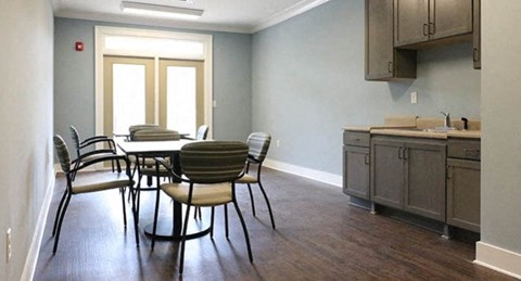 a kitchen and dining room with a table and chairs