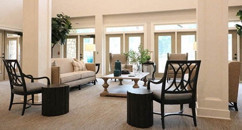 a living room with a couch and chairs and a table