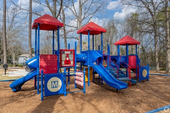 a playground with a blue and red swing set