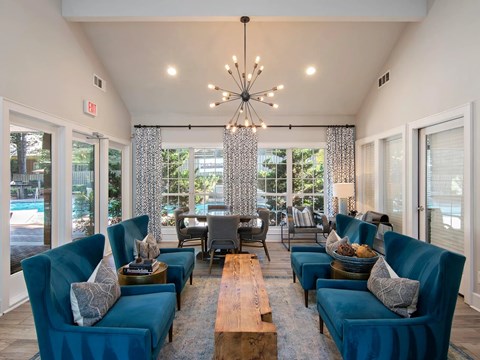 A living room with blue couches and a wooden coffee table.