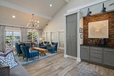 A modern living room with a wooden floor and a brick accent wall.