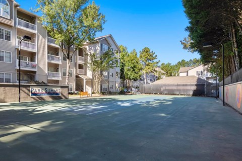 A sunny day at the Park Summit apartment complex with a basketball court.