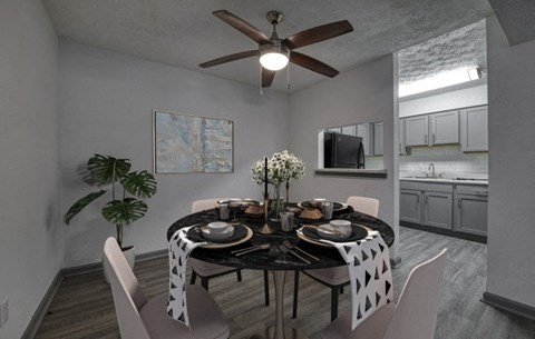 a dining room with a table and a ceiling fan