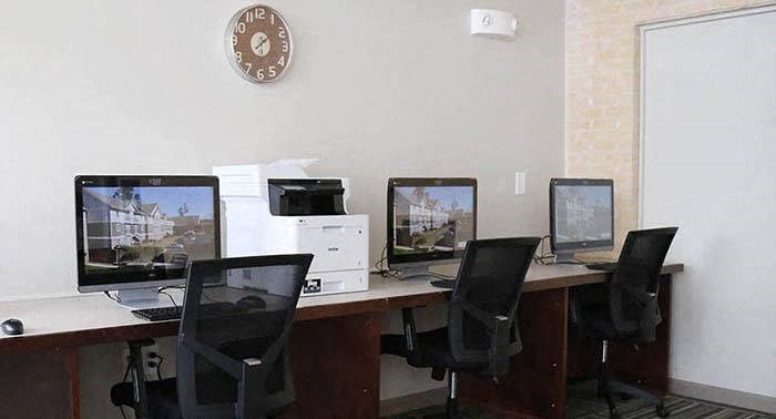 a desk with three computer monitors on it