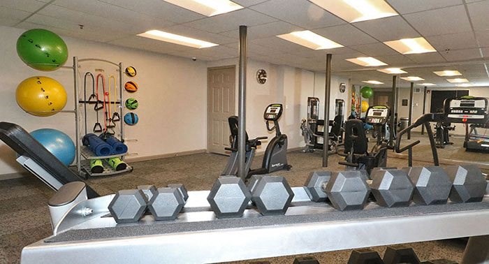 a gym with weights and other exercise equipment in a building