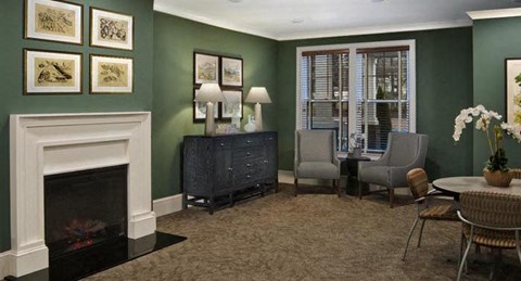 a living room with a fireplace and a table and chairs