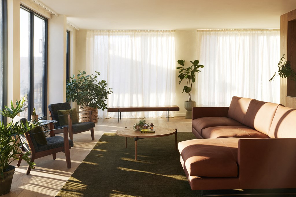 a living room with couches and chairs and a coffee table