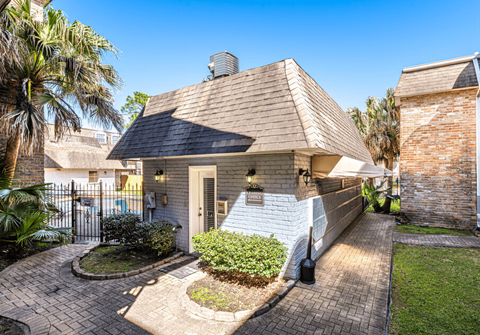 A house with a brick chimney and a white front door.