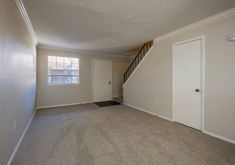 A room with a staircase leading to the second floor.