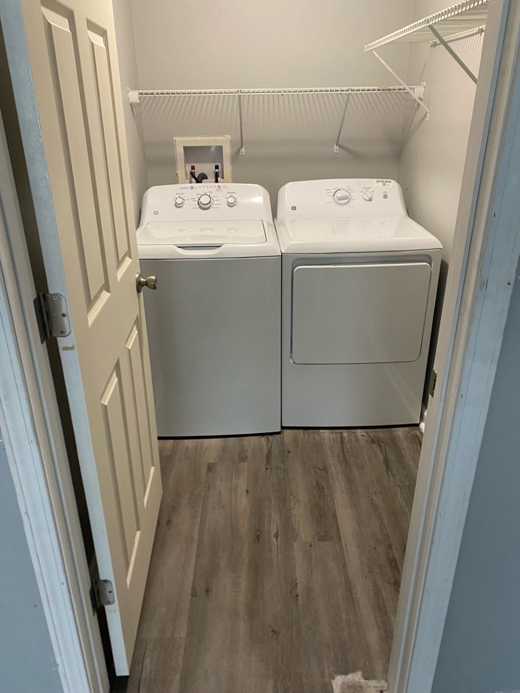 A small laundry room with a washer and dryer.