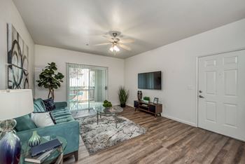 Living Room - Wood plank floors - Ceiling fan - Sliding glass door to Patio - Front entrance