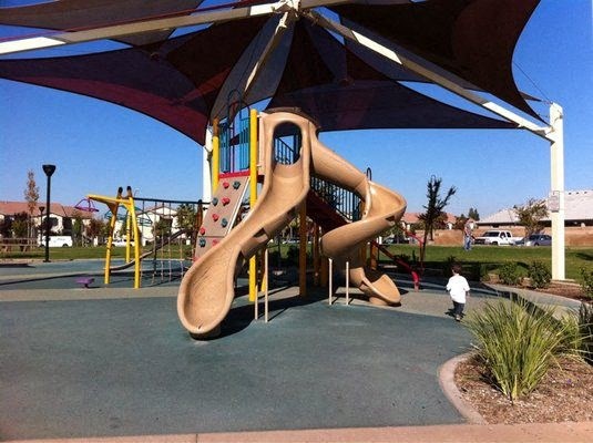 Community Play Ground across the street with slides and small rock wall