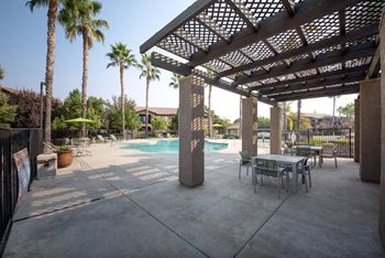Pool area - pergola tables chairs - large deck - Palm trees
