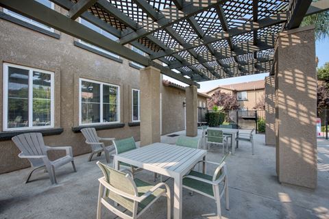 Pergola area of the pool with table and chairs