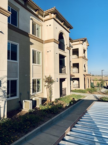 Sidewalk view of apartment building Sidewalk view of apartment building at Villa Annette Apartments, Moreno Valley, CA - Photo Gallery 6