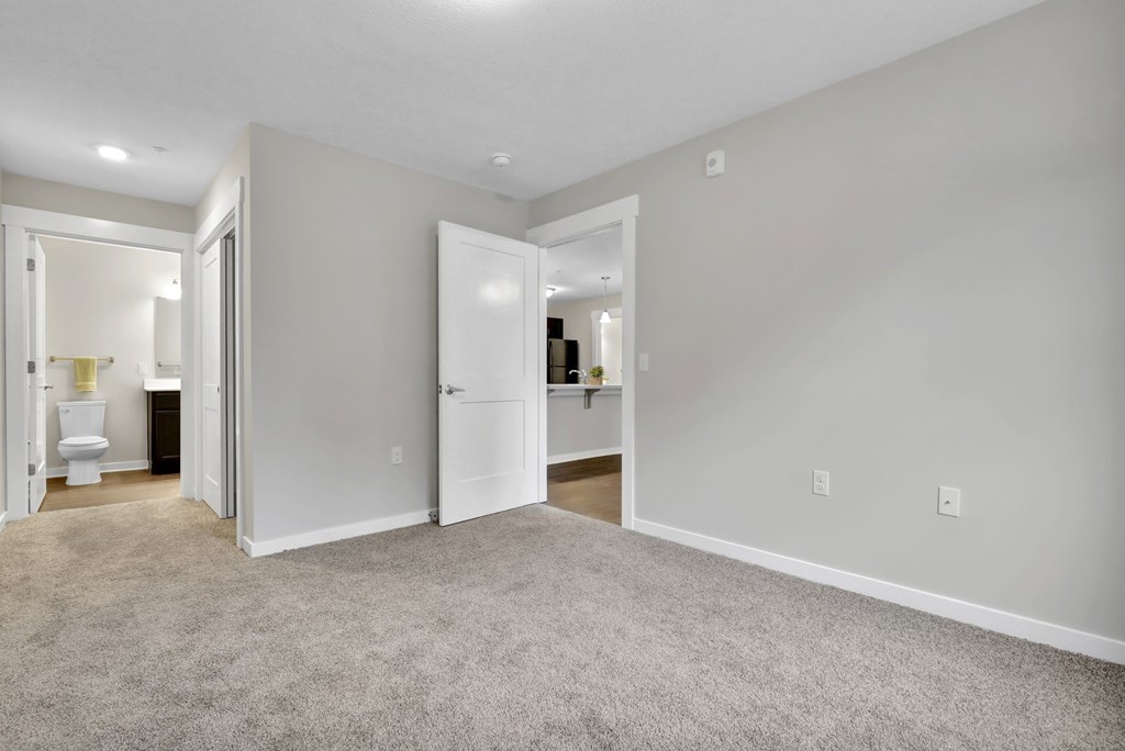 A room with a carpeted floor and white walls.