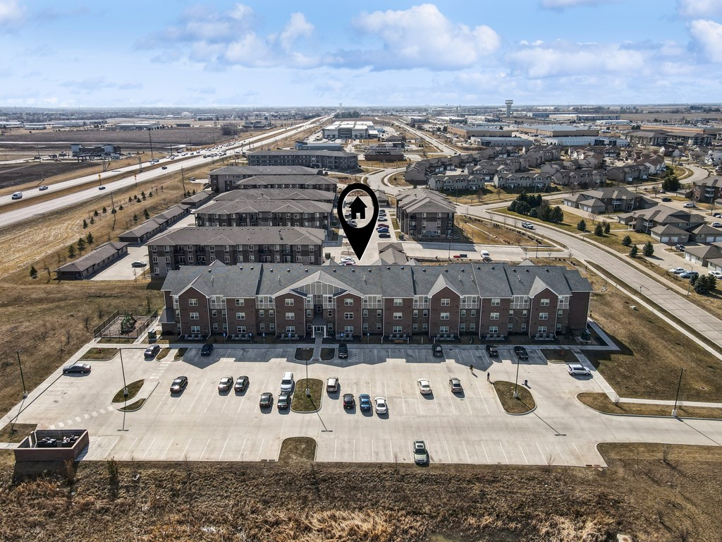 A large building with a parking lot in front of it.