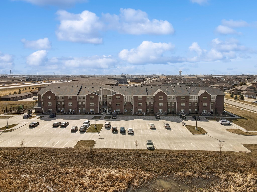 A large building with a parking lot in front of it.