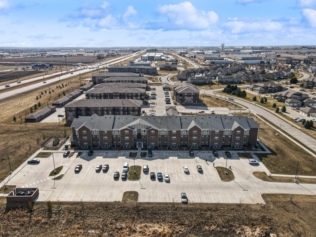A large building with a parking lot in front of it.