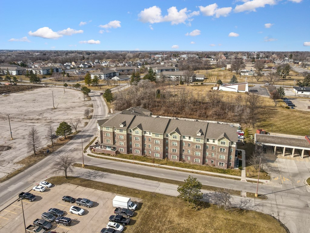 A large building with a parking lot in front of it.