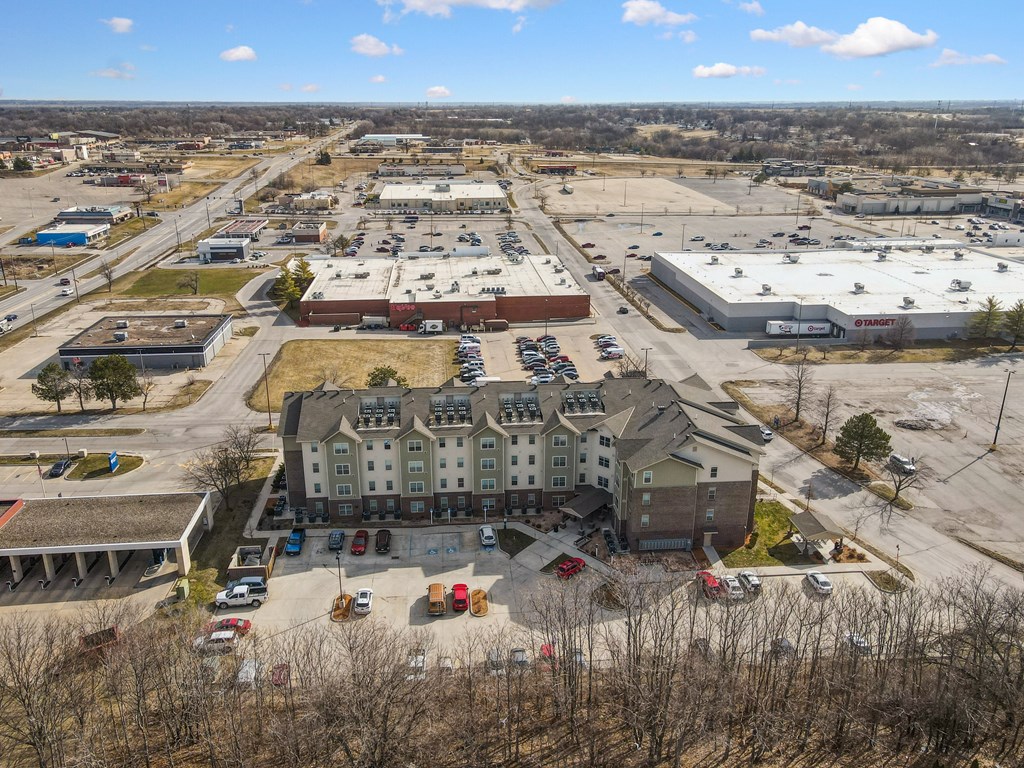 A large building with a parking lot in front of it.