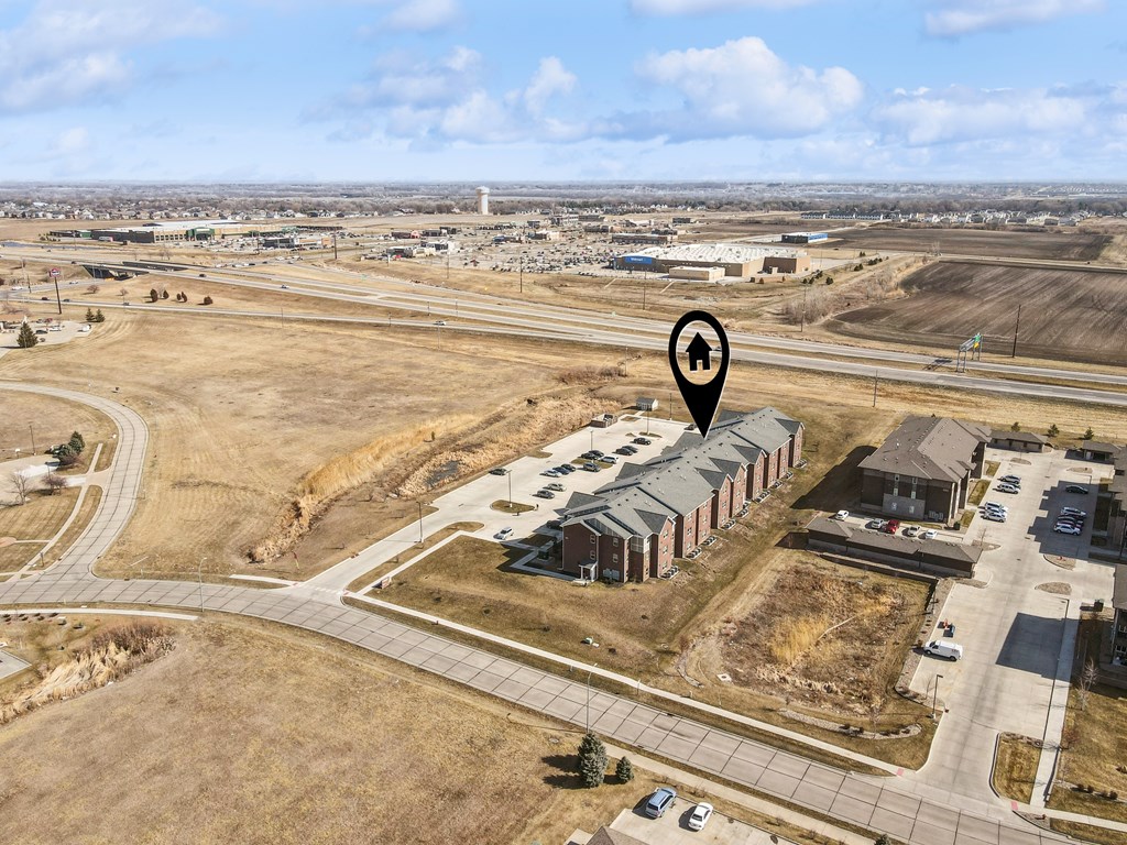 A bird's eye view of a residential area with a house icon pinpointing a specific location.