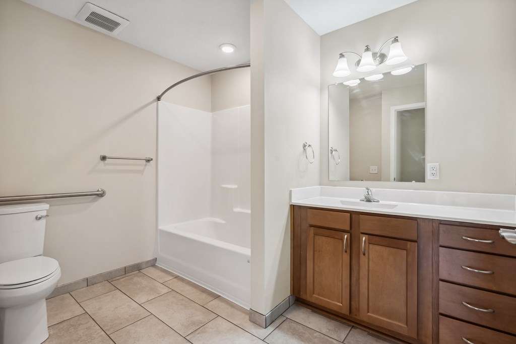 A bathroom with a white toilet, a white sink, and a white bathtub.