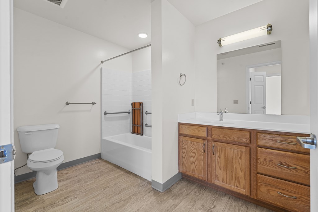 A white bathroom with a toilet, sink, and bathtub.