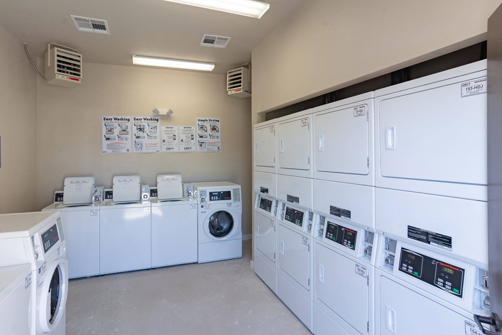 the laundry room is equipped with washers and dryers and plenty of washing machines