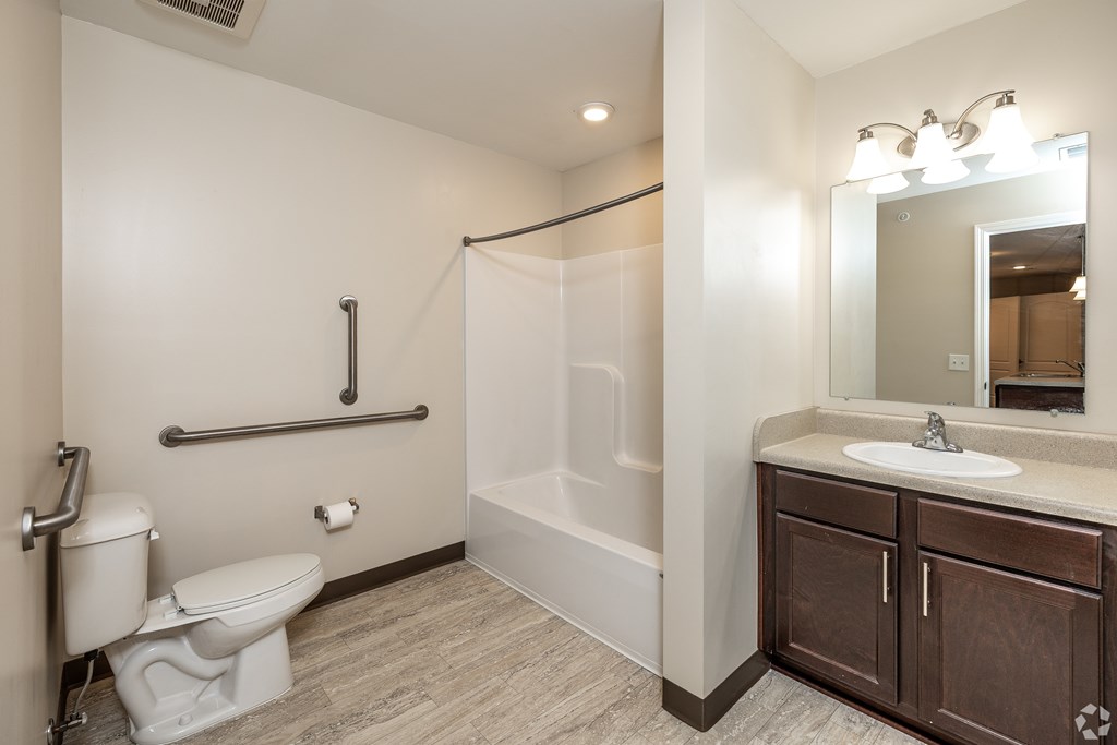A bathroom with a toilet, sink, and bathtub.