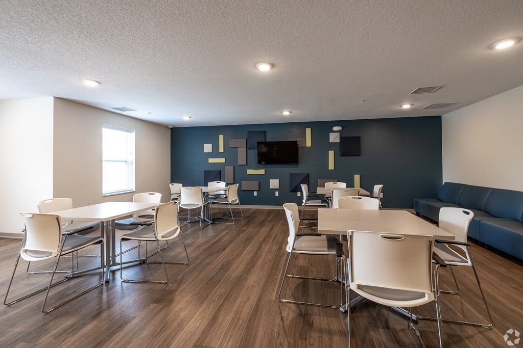 A room with a long table and chairs.