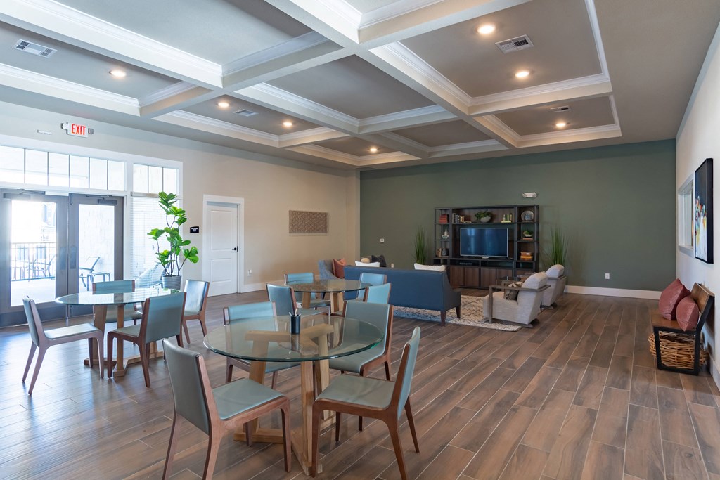 a living room with a table and chairs and a television